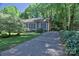 Charming single-story home featuring a well-manicured lawn, a long driveway, and lush landscaping at 10708 Danesway Ln, Cornelius, NC 28031