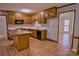 Classic kitchen featuring wood cabinets, marble countertops, and a functional island with wood countertops at 10708 Danesway Ln, Cornelius, NC 28031