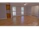 Bright living room features hardwood floors, classic trim, and natural light, creating a spacious and airy atmosphere at 10708 Danesway Ln, Cornelius, NC 28031