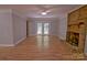 Spacious living room with a fireplace, French doors to the outside, hardwood floors, and crown molding, perfect for entertaining at 10708 Danesway Ln, Cornelius, NC 28031