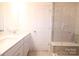 Bright bathroom showcasing a double vanity with white countertops and a glass-enclosed shower at 1075 South Point Rd, Belmont, NC 28012