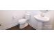 Bright half bathroom features a pedestal sink, toilet, and wood-look flooring at 1075 South Point Rd, Belmont, NC 28012