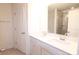 Bathroom featuring double vanity with solid-surface countertops and a large mirror at 1075 South Point Rd, Belmont, NC 28012