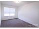 Cozy bedroom with wall-to-wall carpet and a window letting in natural light at 1075 South Point Rd, Belmont, NC 28012