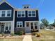 Inviting two-story townhome featuring dark siding, stone accents, and a well-maintained front yard at 1075 South Point Rd, Belmont, NC 28012