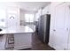 Modern kitchen with white cabinets, stainless steel appliances, a center island, and dark hardwood flooring at 1075 South Point Rd, Belmont, NC 28012