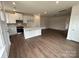 Open-concept living space showcasing hardwood floors and a modern kitchen with a center island at 1075 South Point Rd, Belmont, NC 28012