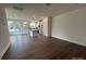Spacious living room with hardwood floors flowing into an open kitchen with white cabinets and stainless appliances at 1075 South Point Rd, Belmont, NC 28012