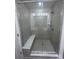 Tiled walk-in shower with built-in bench, rainfall shower head and frameless glass door at 1075 South Point Rd, Belmont, NC 28012