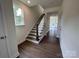 Open staircase design with wood treads, white risers, and a stained wood handrail at 1075 South Point Rd, Belmont, NC 28012