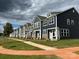 Charming street view of newly built townhomes with landscaped front yards under a cloudy sky at 1075 South Point Rd, Belmont, NC 28012
