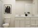 Neutral bathroom offers double sink vanity, art, and a toilet at 1094 Old Trade St, Edgemoor, SC 29712