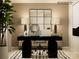 Stylish home office setup featuring a black desk, comfortable chair, modern decor, and ample natural light at 1094 Old Trade St, Edgemoor, SC 29712