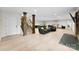 Finished basement features hardwood floors, finished brick wall, recreational space, and stairs to other levels at 11 Secrest Ext, Belmont, NC 28012