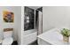 Updated bathroom with sleek black and white tiles, modern fixtures, and a tub-shower combo at 11 Secrest Ext, Belmont, NC 28012