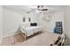 A cozy bedroom featuring natural lighting, neutral paint and carpeting, and a ceiling fan for comfort at 11 Secrest Ext, Belmont, NC 28012