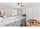 Bright bedroom featuring a bed, wood accent tables, ceiling fan, and a view to the hall and closet at 11 Secrest Ext, Belmont, NC 28012
