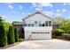 White garage with brick siding home features second story sunroom addition and mature landscaping at 11 Secrest Ext, Belmont, NC 28012