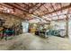 Spacious garage with ample storage, a workbench, bikes, tools, and exposed brick and insulated ceiling at 11 Secrest Ext, Belmont, NC 28012