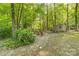 Secluded backyard featuring a cozy firepit area, storage shed, and mature trees for privacy at 110 River Wood Dr, Fort Mill, SC 29715