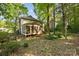 Backyard featuring a screened porch surrounded by mature trees at 110 River Wood Dr, Fort Mill, SC 29715