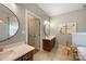 Bathroom featuring double vanities, modern fixtures, and round mirrors at 110 River Wood Dr, Fort Mill, SC 29715