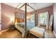 Cozy bedroom with a four poster bed, neutral walls, and ample natural light at 110 River Wood Dr, Fort Mill, SC 29715
