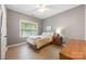 Simple bedroom with natural light, wood floors, and neutral walls at 110 River Wood Dr, Fort Mill, SC 29715