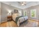 Serene bedroom with tray ceilings, a cozy bed, and natural light from the windows at 110 River Wood Dr, Fort Mill, SC 29715