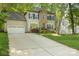 Traditional home with a well-manicured lawn, attached garage, and classic curb appeal at 110 River Wood Dr, Fort Mill, SC 29715
