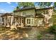 Charming home exterior with a screened porch, brick patio, and lush landscaping at 110 River Wood Dr, Fort Mill, SC 29715