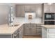 Beautiful kitchen with gray cabinets, granite countertops, and stainless steel appliances at 110 River Wood Dr, Fort Mill, SC 29715