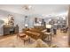 Open-concept living room flows into the kitchen, with a leather sofa and modern decor at 110 River Wood Dr, Fort Mill, SC 29715