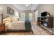 Cozy main bedroom with a tray ceiling, natural light, and a decorative rug at 110 River Wood Dr, Fort Mill, SC 29715