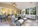 Spacious screened-in porch with cozy seating area and ceiling fan offers a relaxing atmosphere at 110 River Wood Dr, Fort Mill, SC 29715
