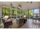 Relaxing screened porch with comfortable seating and views of the wooded backyard at 110 River Wood Dr, Fort Mill, SC 29715