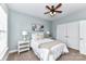 Comfortable bedroom with ceiling fan, two windows, and built-in closet at 11123 Bailey Park Nature Dr, Cornelius, NC 28031