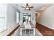 Elegant dining room with wood flooring, wainscoting and stylish ceiling fan at 11123 Bailey Park Nature Dr, Cornelius, NC 28031