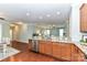Open-concept kitchen with granite countertops, stainless steel appliances, and seamless flow to living area at 11123 Bailey Park Nature Dr, Cornelius, NC 28031