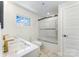 Modern bathroom featuring double sinks, marble countertops, tiled floors, and a glass-enclosed shower for a luxurious feel at 112 Circle Dr, Salisbury, NC 28144