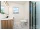 Modern bathroom featuring a vanity with marble countertops and a sleek glass-enclosed shower for a spa-like experience at 112 Circle Dr, Salisbury, NC 28144