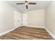 Well-lit bedroom showcasing hardwood floors, neutral paint, a ceiling fan, and ample closet space for convenient storage at 112 Circle Dr, Salisbury, NC 28144