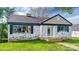 Charming brick home featuring shuttered windows, a quaint front porch and manicured front lawn at 112 Circle Dr, Salisbury, NC 28144