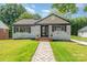 Charming brick home featuring a walkway and well-manicured lawn at 112 Circle Dr, Salisbury, NC 28144