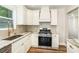 Kitchen featuring stainless steel appliances, a gas range, granite countertops, and a large window at 112 Circle Dr, Salisbury, NC 28144