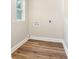 Dedicated laundry room features wood flooring and utility connections at 112 Circle Dr, Salisbury, NC 28144