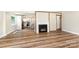 Open-concept living area featuring hardwood floors and a fireplace, connected to the modern kitchen at 112 Circle Dr, Salisbury, NC 28144