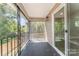 Inviting screened porch with black metal railings, offering a serene outdoor living space and lots of natural light at 112 Circle Dr, Salisbury, NC 28144