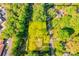 Aerial view highlighting the property lines of the house and lot, showcasing its location and surrounding wooded area at 113 Princess Ln, Dallas, NC 28034