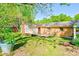 Brick home featuring a patio, well-maintained lawn, and mature trees creating a serene backyard retreat at 113 Princess Ln, Dallas, NC 28034